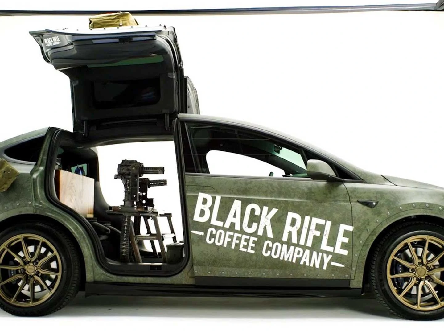 Wild Tesla Model X swaps back seats for dual miniguns and a coffee bar