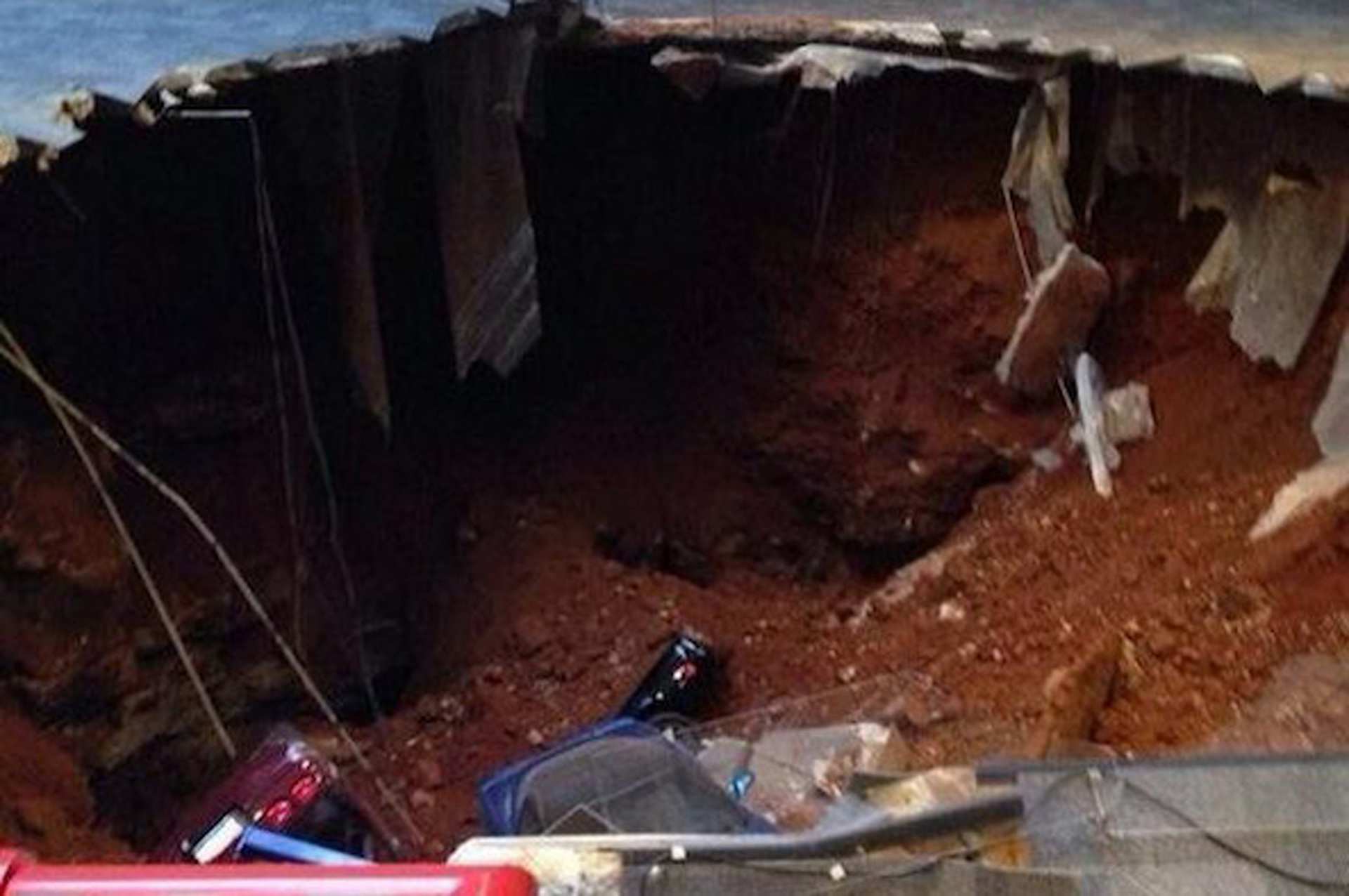 This Must Be the Smallest Sinkhole To Ever Swallow An Entire Car