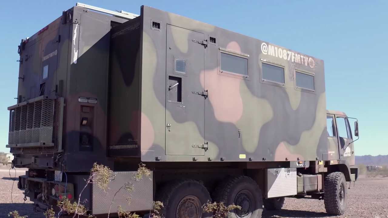 A Military Truck with Extending Sides is Now a Camper with a Solar Roof