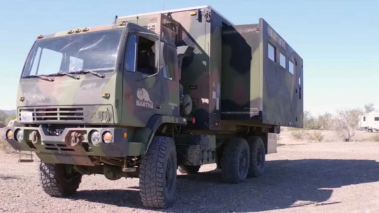 A Military Truck with Extending Sides is Now a Camper with a Solar Roof